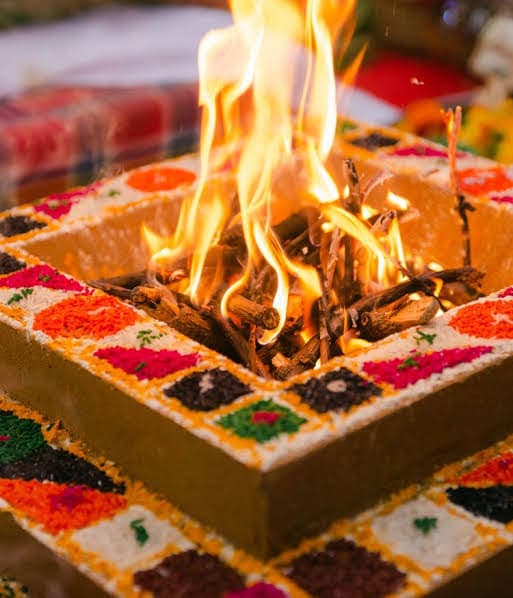 Flames rising from the decorated homa kunda